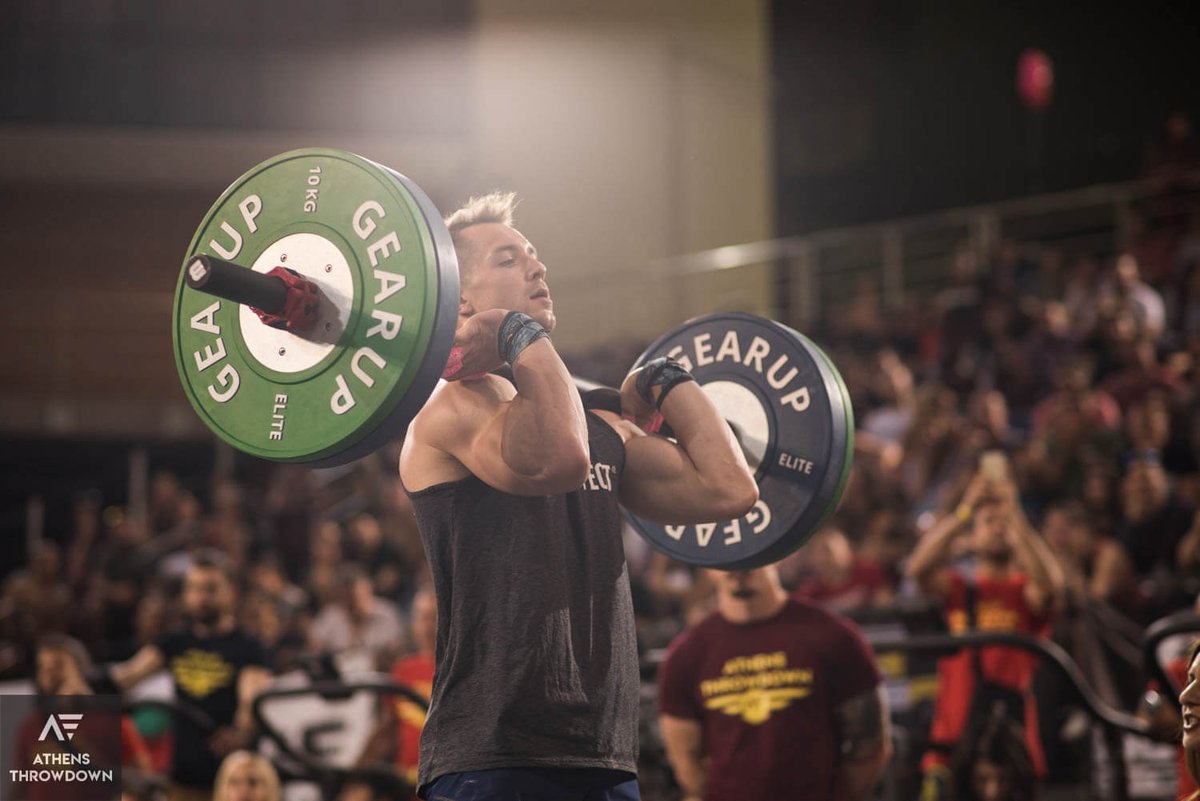 male athlete lifting loaded barbell